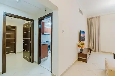 a living room with a sliding glass door at RH - Spacious & Bright 01BR, Walk away to mall of Emirates in Dubai