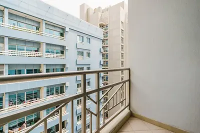 a balcony of a building with buildings in the background at RH - Spacious & Bright 01BR, Walk away to mall of Emirates in Dubai