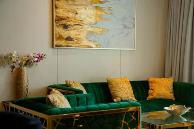 a living room with a green couch and a painting at Five Palm Super Luxury Apt with Full Sea Views in Dubai