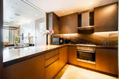 a kitchen with wooden cabinets and a counter top at Five Palm Super Luxury Apt with Full Sea Views in Dubai