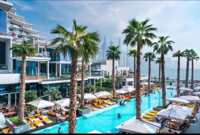 an aerial view of a resort pool with palm trees at Five Palm Super Luxury Apt with Full Sea Views in Dubai