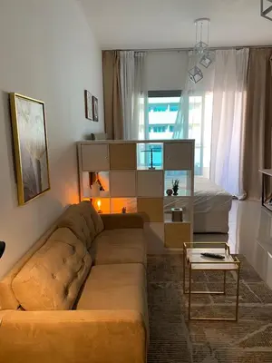 a living room with a couch and a bed at Spacious Studio Apartment in Dubai Marina with Balcony in Dubai