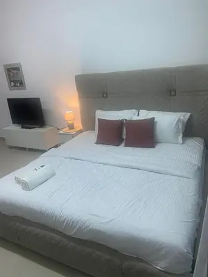 a bedroom with a large bed with two pillows at Spacious Studio Apartment in Dubai Marina with Balcony in Dubai