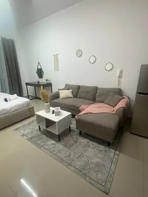 a living room with a couch and a coffee table at Spacious Studio Apartment in Dubai Marina with Balcony in Dubai