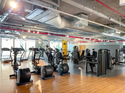 a gym with treadmills and ellipticals in a room at Silkhaus chic 1BDR in the heart of Downtown in new tower in Dubai