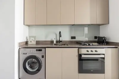 a kitchen with a washing machine and a sink at Frank Porter - 15 Northside Tower 1 in Dubai