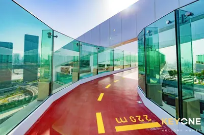 an empty walkway in a glass building at Pristine Cozy One Bedroom Suite in Dubai