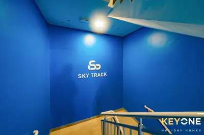 a blue wall with the s sly streak logo on it at Pristine Cozy One Bedroom Suite in Dubai
