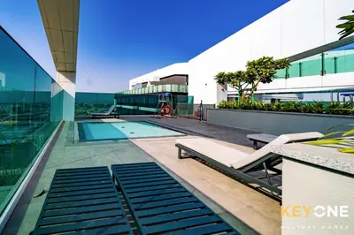 a building with a swimming pool and a building at Pristine Cozy One Bedroom Suite in Dubai