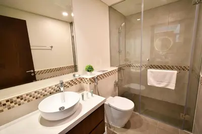 a bathroom with a toilet and a sink and a shower at Vera Residence-Canal Viewing Dubai Mall walking 2BR Chic APT in Dubai