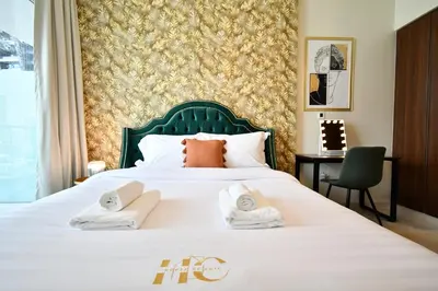 a hotel room with a bed with towels on it at Vera Residence-Canal Viewing Dubai Mall walking 2BR Chic APT in Dubai