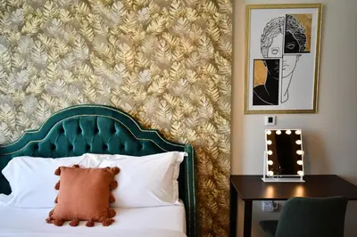 a bedroom with a bed with a green headboard at Vera Residence-Canal Viewing Dubai Mall walking 2BR Chic APT in Dubai