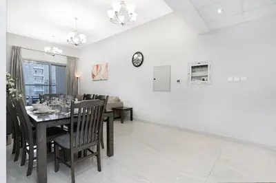 a dining room with a table and chairs at Spacious 4bd en-suite apt I Canal view I Fast wifi in Dubai