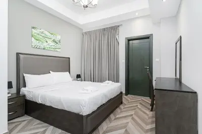 a bedroom with a bed and a desk and a bed at Spacious 4bd en-suite apt I Canal view I Fast wifi in Dubai
