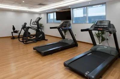 a gym with treadmills and exercise bikes in a room at Spacious 4bd en-suite apt I Canal view I Fast wifi in Dubai
