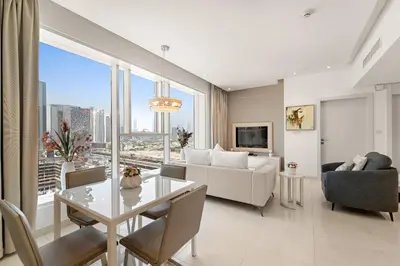 a living room with a couch and a table at Chic 1BR Apt with Sofa Bed, Pool & Burj Khalifa View in Dubai