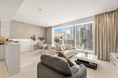 a living room with a view of a city at Chic 1BR Apt with Sofa Bed, Pool & Burj Khalifa View in Dubai