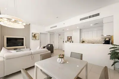 a living room with a couch and a table at Chic 1BR Apt with Sofa Bed, Pool & Burj Khalifa View in Dubai