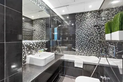 a black bathroom with a sink and a tub at Chic 1BR Apt with Sofa Bed, Pool & Burj Khalifa View in Dubai