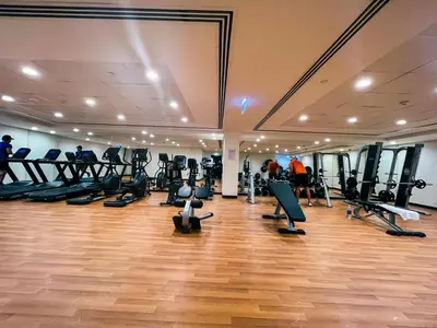 a gym with treadmills and elliptical machines at Green community - Tennis, streetball - 15 mins sea in Dubai