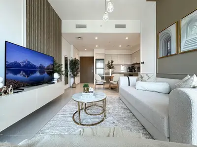 a living room with a large tv on a wall at Trophy - Euphoria Eclipse Suite in 29th floor in Burj Royale in Dubai