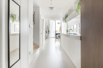 a hallway of a home with a kitchen and a dining room at Frank Porter - The Grand in Dubai