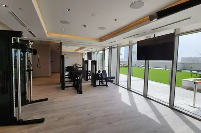 a gym with tread machines and a flat screen tv at STAY BY LATINEM Luxury 1BR Holiday Home CVR A702 near Burj Khalifa in Dubai