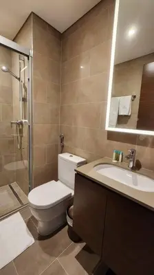 a bathroom with a toilet and a sink and a shower at STAY BY LATINEM Luxury 1BR Holiday Home CVR A702 near Burj Khalifa in Dubai