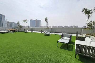 a large lawn with benches and chairs on a roof at STAY BY LATINEM Luxury 1BR Holiday Home CVR A702 near Burj Khalifa in Dubai
