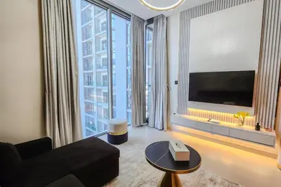 a living room with a couch and a large window at STAY BY LATINEM Luxury 1BR Holiday Home CVR A702 near Burj Khalifa in Dubai