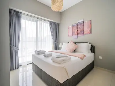 a bedroom with a large bed with towels on it at Business Bay's Coziest Hideaway With Balcony in Dubai