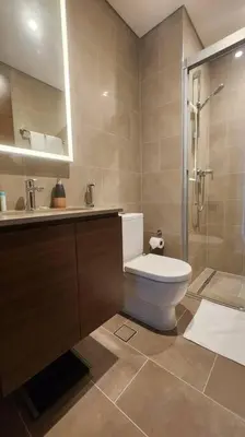 a bathroom with a toilet and a sink and a shower at STAY BY LATINEM Luxury 1BR Holiday Home CVR A703 near Burj Khalifa in Dubai
