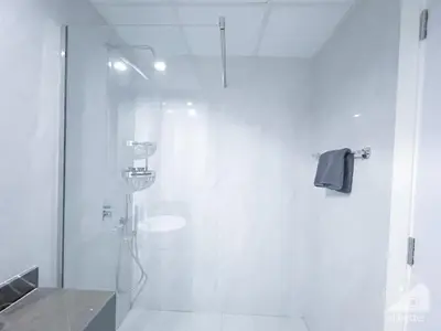 a bathroom with a shower with a glass door at Spacious Studio with balcony in AL Majan in Dubai