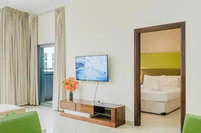 a living room with a couch and a mirror at RH- Exquisite & Spacious 01 BR, Near Mall of the Emirates in Dubai