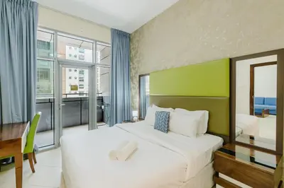 a bedroom with a large bed and a large window at RH- Exquisite & Spacious 01 BR, Near Mall of the Emirates in Dubai