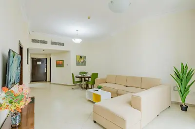 a living room with a couch and a table at RH- Exquisite & Spacious 01 BR, Near Mall of the Emirates in Dubai