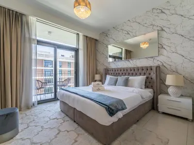 a bedroom with a large bed and a large window at Dazzling 1BR in Park Point - Dubai Hills in Dubai