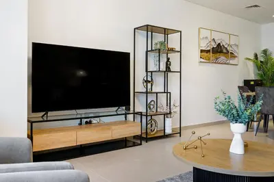 a living room with a large flat screen tv at Extravagant 3BR + kid's room w/ Burj Khalifa view in Dubai