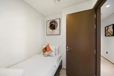 a bedroom with two beds and a wooden door at Extravagant 3BR + kid's room w/ Burj Khalifa view in Dubai