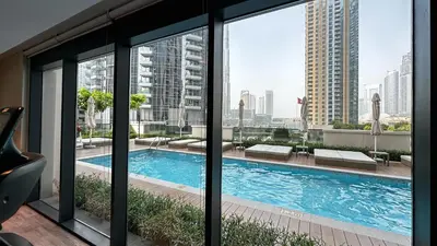 a view of a swimming pool from a building at Extravagant 3BR + kid's room w/ Burj Khalifa view in Dubai