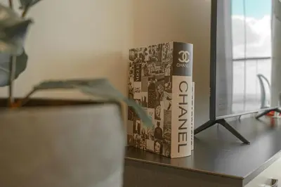 a book sitting on a desk next to a computer monitor at Paramount Tower Hotel and Residences with Infinity Sky Pool in Dubai