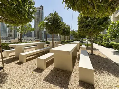 a row of white benches in a park at Vogue Downtown Burj Royale near Dubai Mall and Burj Khalifa ,Two Bedroom Apartment with large Balcony and Access to all Amenities in Dubai