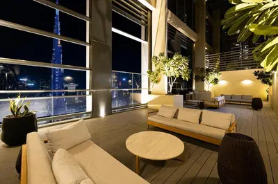 a living room with couches and tables in a building at Vogue Downtown Burj Royale near Dubai Mall and Burj Khalifa ,Two Bedroom Apartment with large Balcony and Access to all Amenities in Dubai