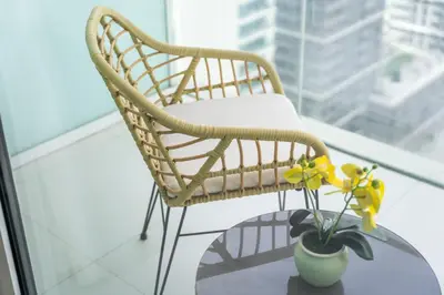 a chair and a vase on a table with a plant at Sunrise Bay with treasure stunning harbour view by Suiteable in Dubai