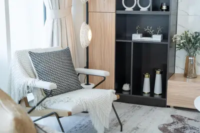 a living room with a chair and a shelf at Sunrise Bay with treasure stunning harbour view by Suiteable in Dubai