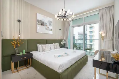 a bedroom with a large bed and a large window at Sunrise Bay with treasure stunning harbour view by Suiteable in Dubai