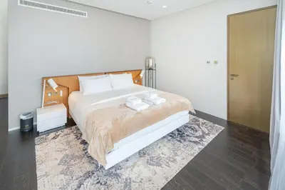 a bedroom with a bed with two towels on it at Luxury 2BR Panoramic Marina Views High Floor in Dubai