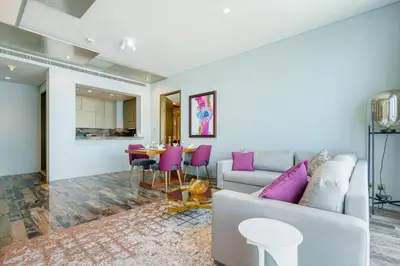 a living room with a couch and a table at Luxury 2BR Panoramic Marina Views High Floor in Dubai