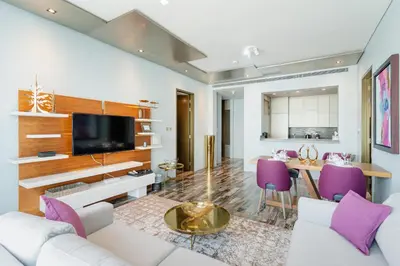 a living room with white furniture and purple chairs at Luxury 2BR Panoramic Marina Views High Floor in Dubai