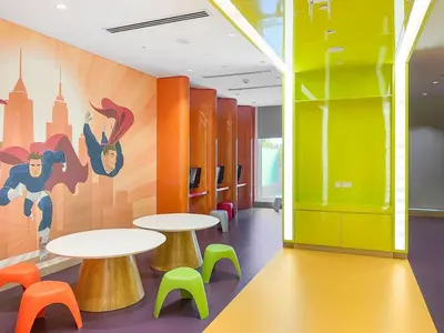 a cafeteria with two tables and colorful chairs at ALiving Classy Private Studio I Canal Views I DAMAC Maison Prive A- 2111 in Dubai
